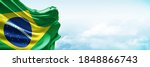 Brasil flag in the blue sky. Horizontal panoramic banner.