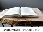 Small photo of Flat lay open Bible, Greek New Testament. On wooden background. Baselland, Switzerland 12.05.2019
