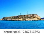 Small photo of Energizing view from Tremiti Islands (Isole Tremiti) in the Adriatic Sea at the balmy sandy colors of the rocky spur, interspersed with vegetation, technological towers, amongst creamy deep blue sea