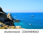 Small photo of Inspiring view from Tremiti Islands (Isole Tremiti) at rocky slopes in the left foreground opening to a sublime vision of extensive, only slightly perturbed Adriatic Sea, with motorboats and ships