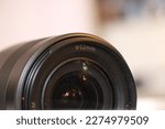 Small photo of Close Up of a standard camera lens. Photography, art, social media and business themed photo with minimal editing. 52mm camera lens for marketing and reference photos.