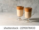 Dalgona coffee. Iced whipped coffee and milk. Refreshing coffee drink in glass cups, copy space
