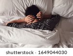 Preteen tween boy covering ears with his hands in bed, ADHD, Autism,sleep disorder, mental health in children, not want to hear, wake up kid for school , teen autism down syndrome awareness concept