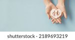 Small photo of Hands holding elderly couple with walking sticks in heart shape, older people mental health, age care concept