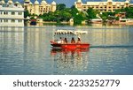 Small photo of Udaipur, Rajasthan, India - September 4 2022: Beautiful view of Lake Palace. Tourists boat riding in lake. India. Jag Niwas in Lake Pichola for the royal dynasty of Mewar. Cityscape, Udaipur tourism