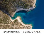 Aerial overhead drone shot of yacht on Adriatic sea curvy cove on Vis Island in Croatia summer morning
