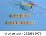Small photo of Syringes with opioid, analgesic and neuromuscular blocker in a light blue background and words write general anesthesia