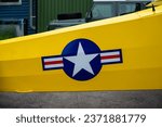 Small photo of Kjeller, Norway - June 18 2023: US Airforce Roundel on the fuselarge of a yellow airplane.