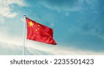 Small photo of China national flag waving in beautiful sky.