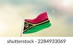 Small photo of Waving flag of Vanuatu in beautiful sky. Vanuatu flag for independence day.