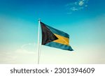 Small photo of Waving flag of The Bahamas in beautiful sky. The Bahamas flag for independence day.