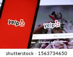 Small photo of Mobile phone with Yelp icon on full screen close up with website on laptop. Blurred background with Yelp logo. Los Angeles, California, USA - 9 November 2019, Illustrative Editorial