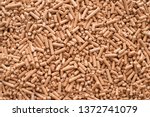 Wooden pellets background, pattern. Close up natural wood pellet. Ecological heating, renewable energy Biofuels. Top view. Flat lay ecological fuel for solid fuel boilers. 