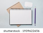 Notepad, white sticker and pensil on the desk. Mock up in copy space office background. It is important not to forget the note