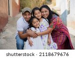 Portrait of a Latin family hugging in rural area - Happy Hispanic family in the village