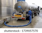 Small photo of Normandy, France, April 2008. Dairy plant Danone. Milk storage tank. Milk tanker trucks in the unloading area