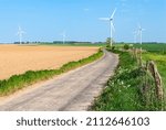 Small photo of Picardy, France, May 2007. Wind farm with 5 wind turbines of 2 megawatts in the Somme. Potato field. Countryside road