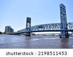 Small photo of Jacksonville, FL - May 2022: Main street Bridge in downtown Jacksonville, over St Johns River. Blue moveable bridge for car and pedestrian crossing