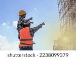 Small photo of Engineer father carrying son on shoulder showing his construction building project in construction site ,male contractor daddy taking son to see building site, father and son relationship concept