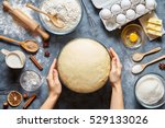 Hands working with dough preparation recipe bread, pizza or pie making ingridients, food flat lay on kitchen table background. Butter, milk, yeast, flour, eggs, sugar pastry or bakery cooking.