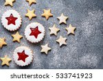 Christmas or New Year homemade cookies star with strawberry jam. Flat lay.Traditional Austrian christmas cookies - Linzer biscuits filled with red strawberry jam. Top view. Copy space.