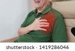 Small photo of Old man has chest pain and painful facial expression. Chest pain symptom may be from medical emergency heart disease as angina, myocardial infarction, acute coronary syndrome, pericarditis disorder.