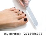Small photo of medical pedicure with a nail file. Foot peeling procedure in the spa using a special apparatus. Clinic of Podiatry Podiatry.