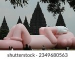 Small photo of Contemporary artwork by world artist Brian Donnelly or KAWS can be seen during an exhibition entitled 'Kaws: Holiday Indonesia' in the Prambanan Temple Complex, Sleman, Yogyakarta on August 19, 2023.