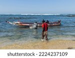 Small photo of Dakar, Senegal. August 18, 2019: Fishermen with a fishing boat in a beach at Dakar, one of the many fishing beaches of Dakar, Senegal, West Africa