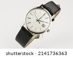 Small photo of puristic antique silver watch swiss made used worn wristwatch isolated elegant noble retro classic luxurious front view close up Macro rare pocketwatch with black leather bracelet band strap modern