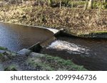 Small photo of River water flowing over small weir making white foam grassy banks Huddersfield Yorkshire England 02-01-2022 by Roy Hinchliffe