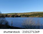 Small photo of Reservoir blue water and sky far treelined bank fields in background Huddersfield Yorkshire England 05-01-2022 by Roy Hinchliffe