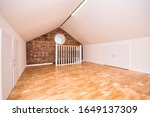 Loft Room Conversion with Circular Window and Exposed Bricks UK