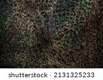 Small photo of Military camouflage mesh texture background. Dark, brown and green material surface backdrop. Army style camo netting for camping, fishing and hunting. Hiding, staying safe in the forest. Copy space
