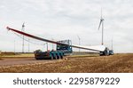 Small photo of wind turbines under construction. Blade for wind turbines close up. Special transport of a blade for a wind turbine on a special semi-trailer