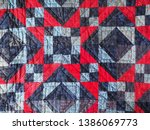 Small photo of Detail of Blue and Red Patchwork Quilt with Hand Quilting