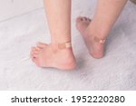 Small photo of Closeup of woman's heel with blister plaster on, women's problems with shoes that are too tight, making them uncomfortable and blistering.