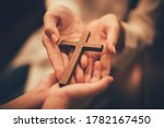 Woman's hand with cross .Concept of hope, faith, christianity, religion, church online.