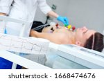 Small photo of Electrocardiogram, ECG in hand. Clinic of Cardiology heart rate and pulse test closeup. Cardiogram printout on a male patient background