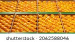 Small photo of Panoramic view of a multitude of mandarins placed in rows inside boxes.