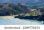Small photo of Recondite beaches in the north of Spain, with houses in the green fields next to the mountains, Lastres, Asturias.