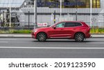 Small photo of Moscow, Russia - July 2021: Side view of Volvo XC60 second generation T5 AWD suv in motion. Red pre-facelift styling CUV car moving on the street