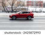 Small photo of Moscow, Russia - 14 February 2024: Side view of Volvo XC60 second generation T5 AWD suv in motion. Red pre-facelift styling CUV car moving on the street