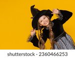 A young witch in a black fluffy ...