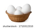 
Eggs. White chicken eggs in a basket isolated on a white background.