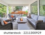 Small photo of A luxurious spacious deck with stylish patio furniture with a fire pit table heater