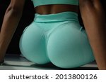close up of buttocks fitness woman in sportswear. Home fitness workout. Female athletic glutes and legs close up.