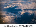 Aerial View from Airplane of Snow Covered high mountains in Iceland.  Aerial view of snow-capped mountains.