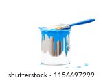 open, painted bucket and paintbrush on a white backdrop.