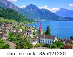 Little swiss town with gothic church on Lake Lucerne and Alps mountain, Switzerland